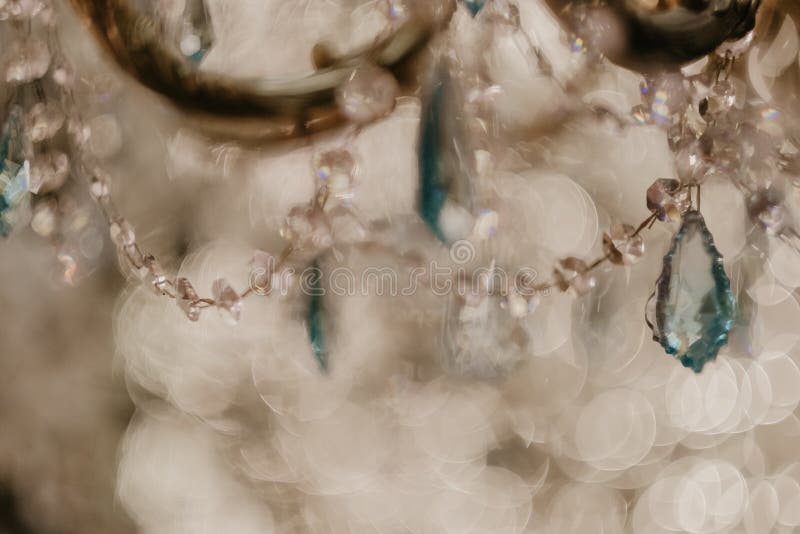 Selective focus shot of glass crystals hanging on a luxury chandelier. A selective focus shot of glass crystals hanging on a luxury chandelier stock photos