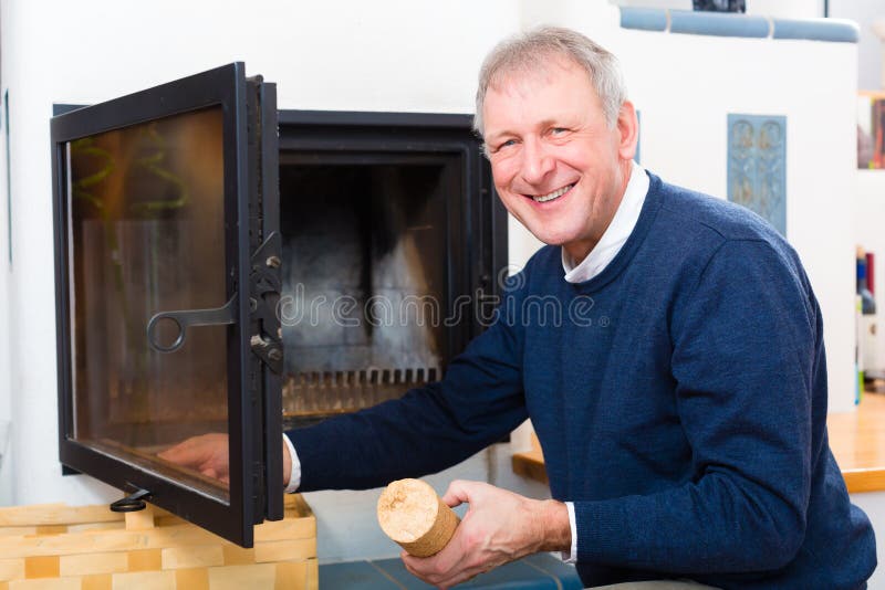 Senior at home in front of fireplace royalty free stock photos