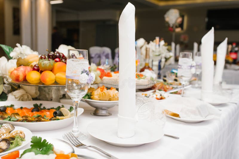 Serving a festive wedding Banquet table. A white napkin is on the plate stock photo