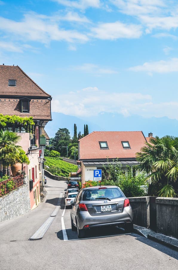 St. Saphorin, Switzerland - July 9, 2019: Street in rural winemaking village Saint Saphorin in Swiss Lavaux wine region. Houses. Located on the slope above the royalty free stock images