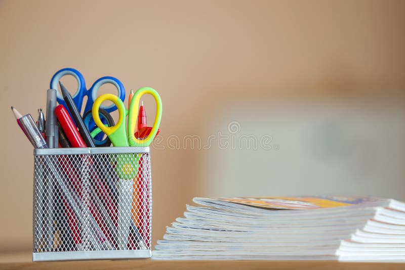 Stack of notebooks and stationery arrangement in classroom or office on copy space background.  stock photos