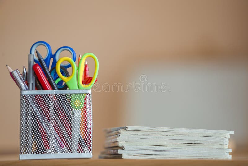 Stack of notebooks and stationery arrangement in classroom or office on copy space background.  stock images