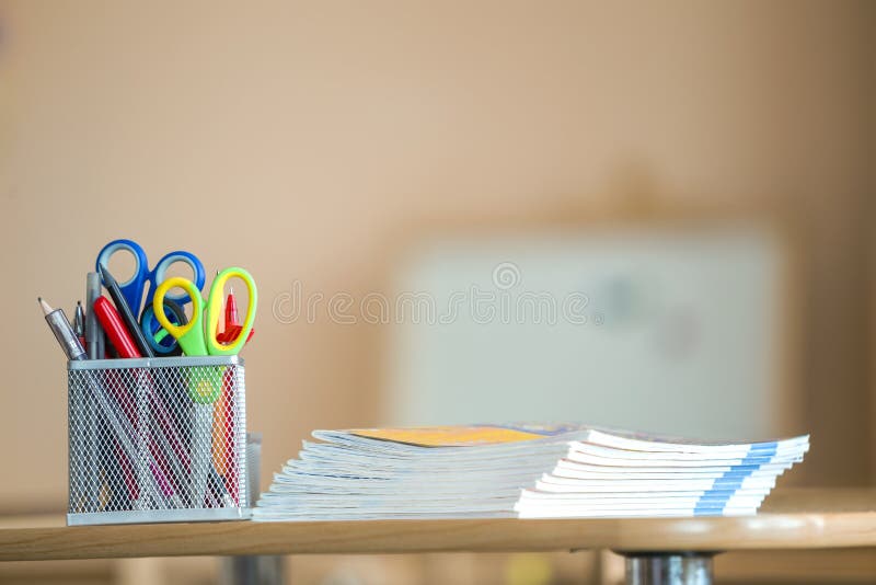 Stack of notebooks and stationery arrangement in classroom or office on copy space background.  royalty free stock photography