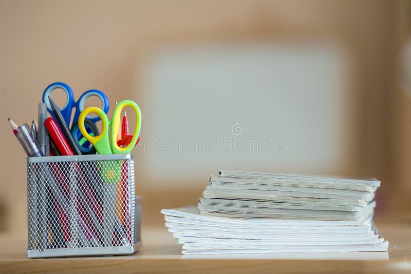 Stack of notebooks and stationery arrangement in classroom or office on copy space background.  royalty free stock photography