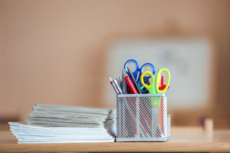 Stack of notebooks and stationery arrangement in classroom or office on copy space background.  stock photo