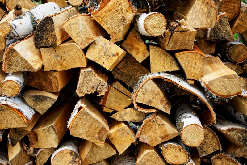 Stacked birch firewood prepared for kindling. Eco-friendly and natural items stock photos
