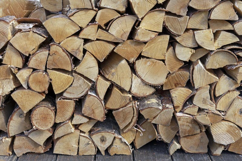 Stacked firewood for kindling a stove, fireplace, barbecue or bonfire. Firewood background. Wood texture stock photo