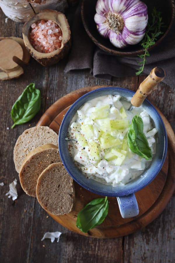 Summer light salad tzatziki: Greek yoghurt, garlic, green herbs and cucumber. Rustic style, top view royalty free stock image