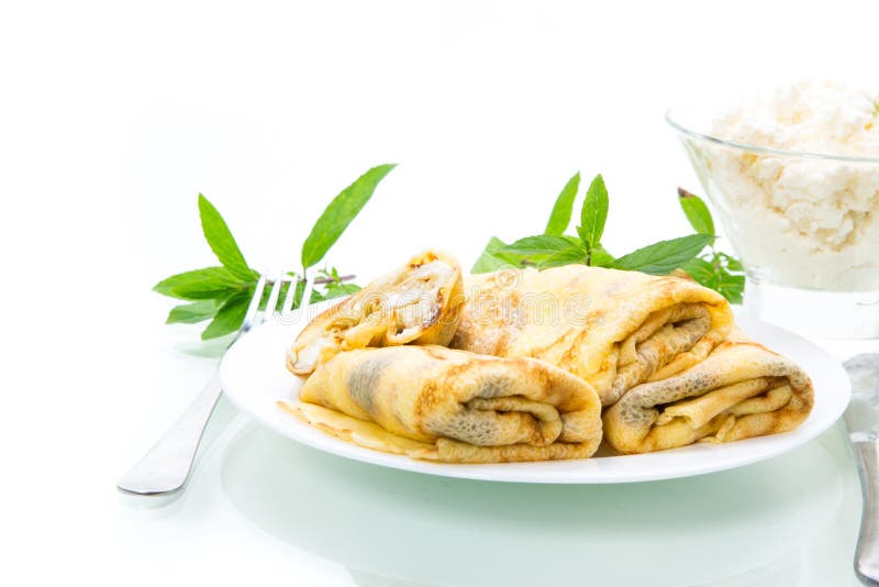 Sweet fried thin pancakes with cottage cheese inside. Isolated on white background royalty free stock photos