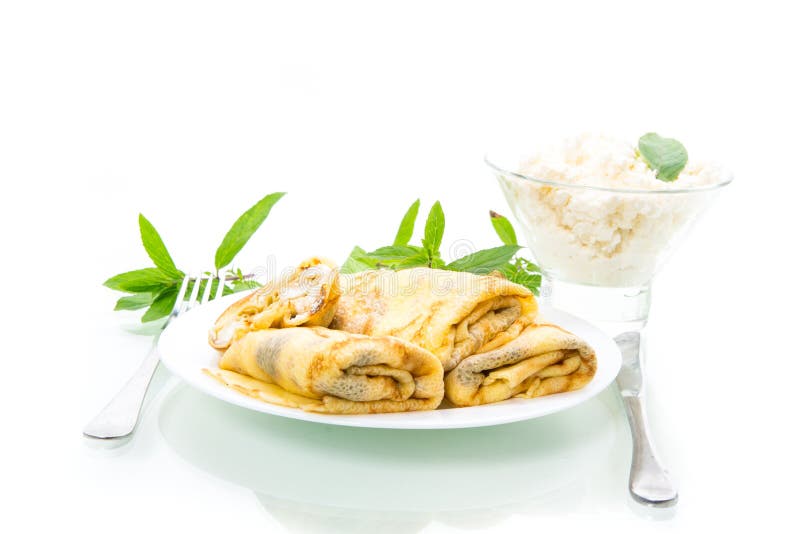 Sweet fried thin pancakes with cottage cheese inside. Isolated on white background stock photo