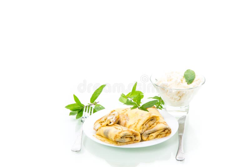 Sweet fried thin pancakes with cottage cheese inside. Isolated on white background stock image