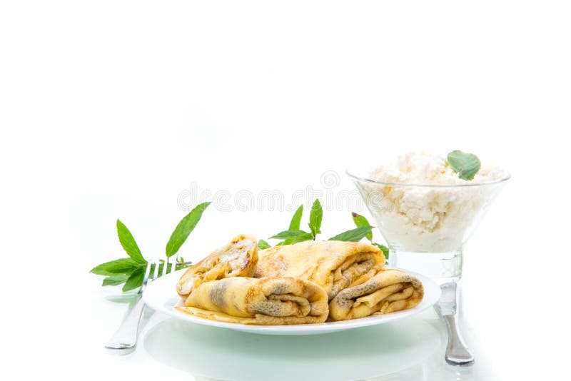 Sweet fried thin pancakes with cottage cheese inside. Isolated on white background stock photos