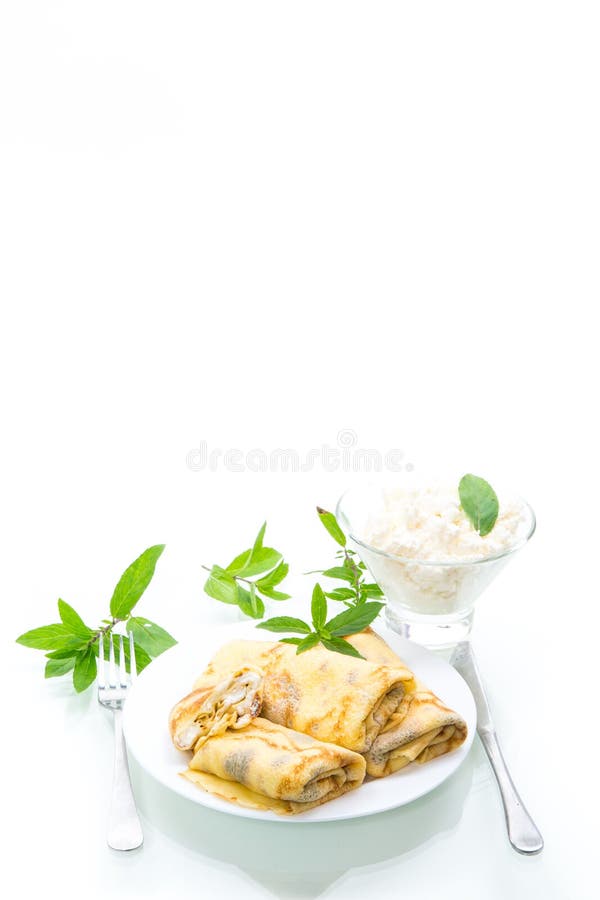 Sweet fried thin pancakes with cottage cheese inside. Isolated on white background stock image