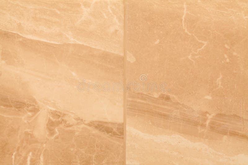 Two marble effect wall tiles. Closeup of two brown and cream, marble effect wall tiles positioned side by side but not matched for alignment of grain structure stock photography