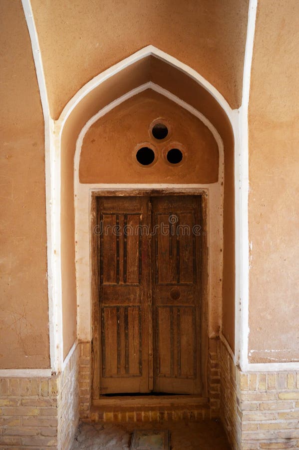 View of a beautiful old Iranian door on the walls of an old house in Yazd, Yazd has a unique Iranian architecture. View of a beautiful old Iranian door on the royalty free stock images