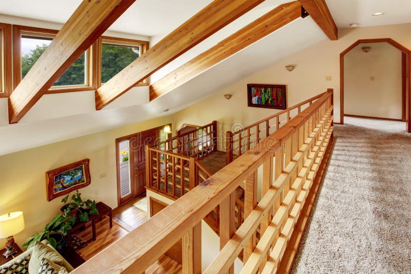 View from the hallway into the living room in the loft style. Wooden beams on the ceiling. stock images