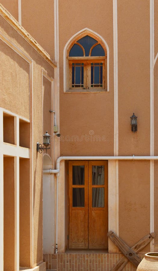 View of traditional Persian doors and windows on the walls of an old house in Yazd, Yazd has a unique Iranian architecture. Yazd is one of the oldest cities in royalty free stock photos