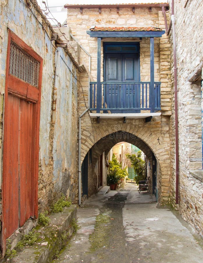 Vintage blue balcony above the arch in stone house, Lefkara village Cyprus. Old street with stone buildings n famous Cyprus see sights village Lefkara. Blue stock photo