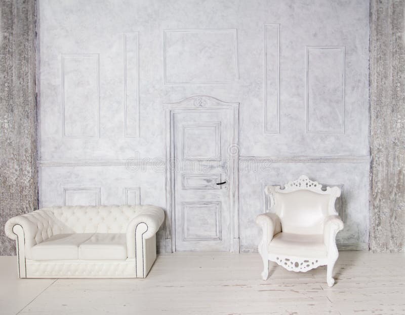 Vintage Interior with Sofa, Armchair, Stucco Wall and Door. Gray Background royalty free stock photo