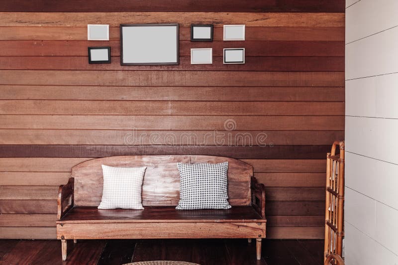 Vintage old wooden wall living room with wooden couch, pillows, stock photo