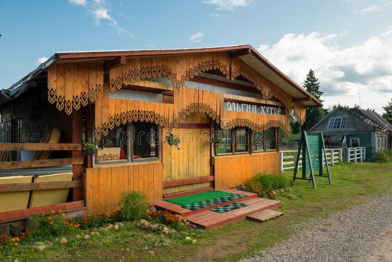 The building of the cafe Holguin farm. Authentic rural wooden house in village with carved entrance gates royalty free stock photo