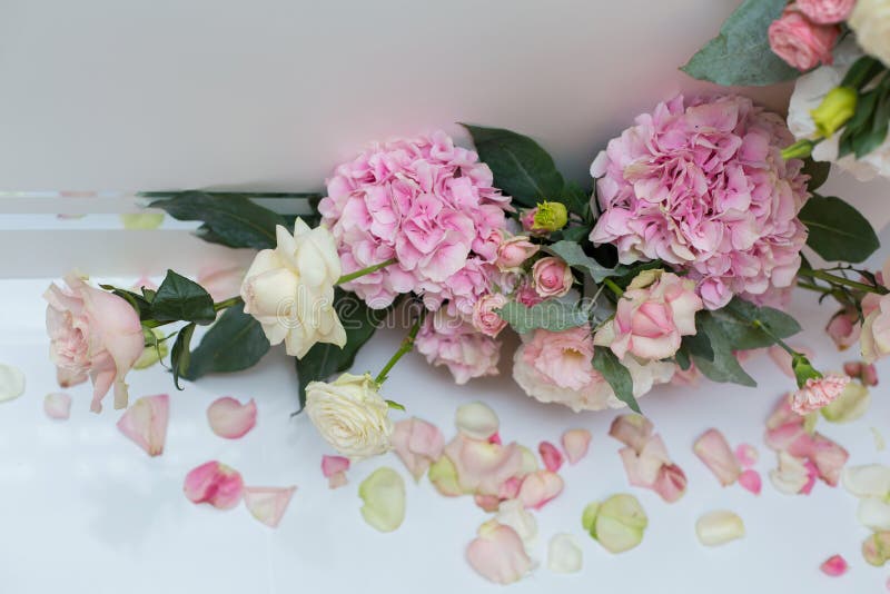 Wedding decorations. Holiday decoration vase with fresh flowers near the wedding arch. Pink roses and carnations stock image