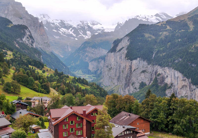 Wengen in the swiss Alps. In a valley with rural houses, in the background are mountains on a cloudy day royalty free stock photos