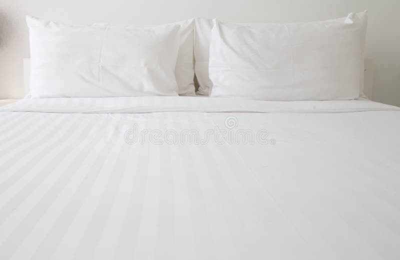 White bed sheets and pillows royalty free stock image