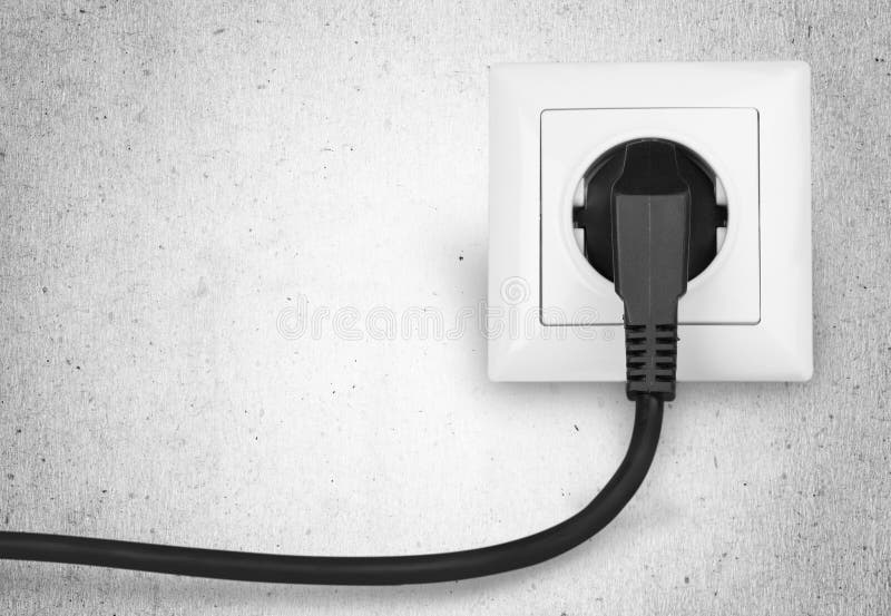 White electrical plug in the electric socket on royalty free stock photography