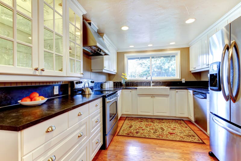 White kitchen interior with large sink and window. stock photography