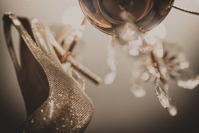 White wedding shoes hanging on the chandelier. White wedding shoes hanging on the chandelier royalty free stock images