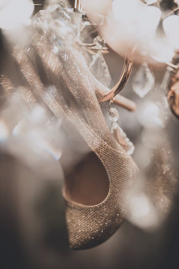 White wedding shoes hanging on the chandelier. White wedding shoes hanging on the chandelier royalty free stock image