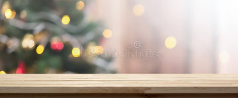 Wood table top on colorful bokeh background from decorated Chrismas tree royalty free stock photos