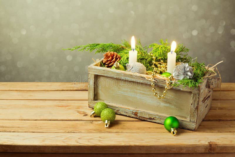 Wooden box with Christmas decorations and candles over dreamy background. Christmas table composition royalty free stock photos Wooden box with Christmas decorations and candles over dreamy background. Christmas table composition royalty free stock photos