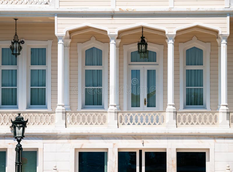 Wooden mansion close up detail. Beautiful classic architecture balcony with arch  columns and many windows stock images