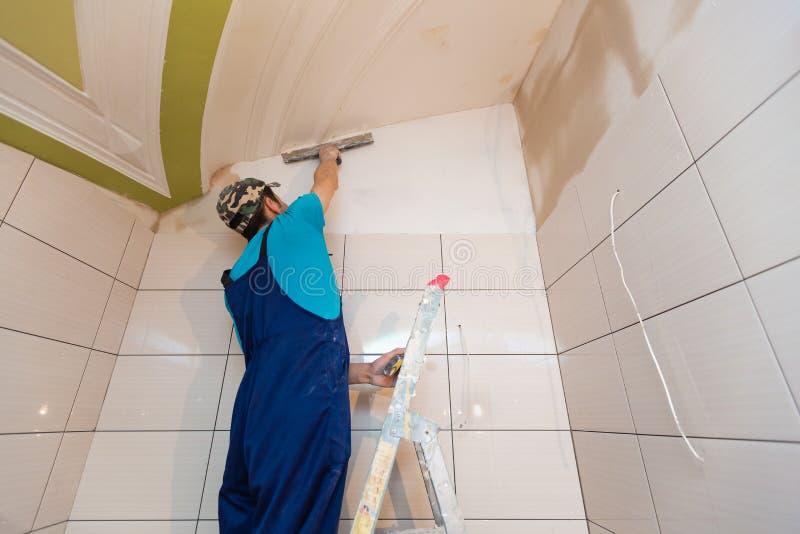 Worker are putting up the wall from ladder in apartment is under construction, remodeling, renovation, overhaul. Extension, restoration and reconstruction royalty free stock images