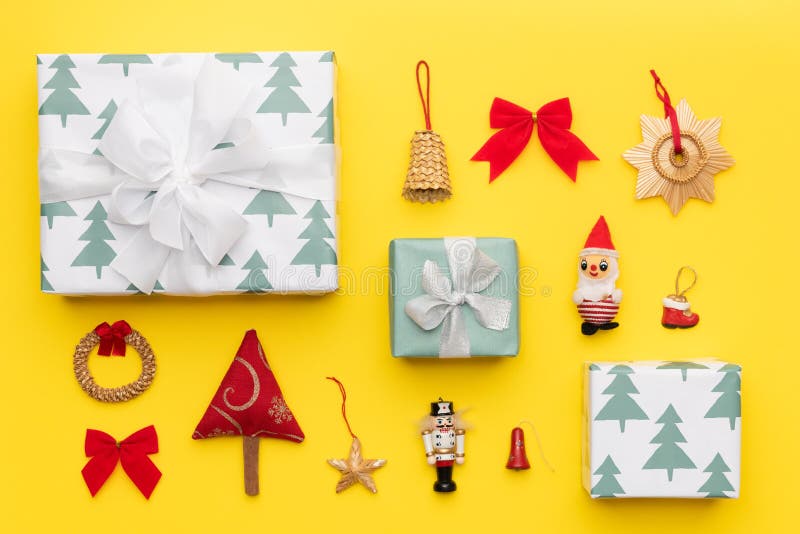 Wrapped christmas gifts and many retro christmas ornaments isolated on bright yellow background. Christmas composition. royalty free stock image Wrapped christmas gifts and many retro christmas ornaments isolated on bright yellow background. Christmas composition. royalty free stock image