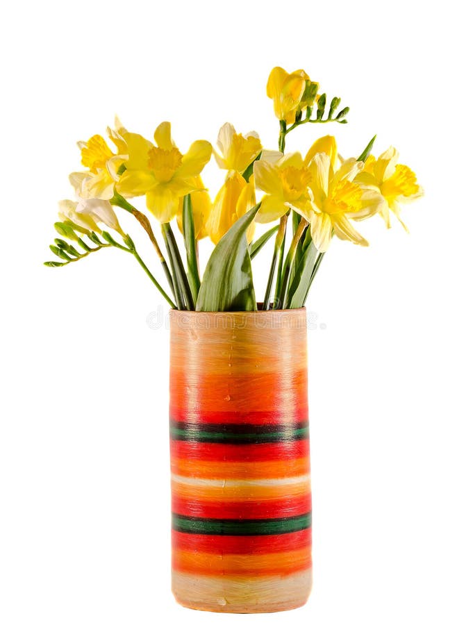 Yellow daffodils and freesias flowers in a vivid colored vase, close up, isolated, white background.  stock image