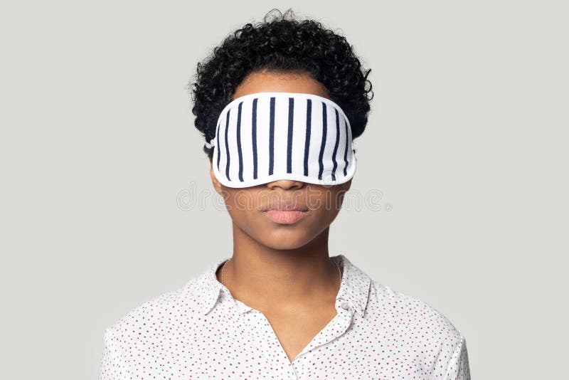 Young african american woman standing with sleeping mask on eyes. royalty free stock photos