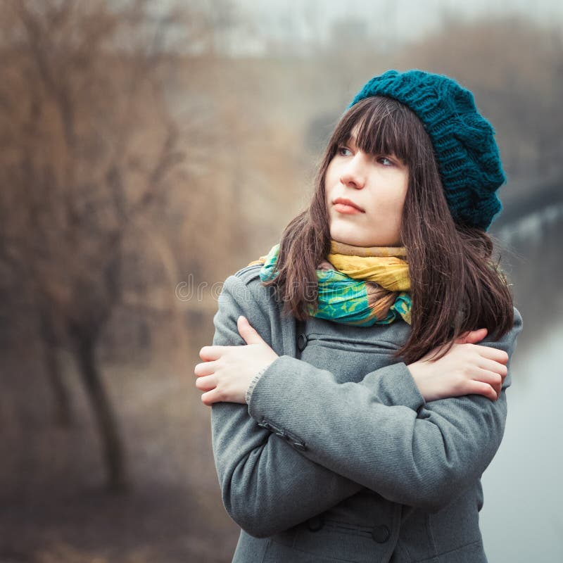 Young pretty girl in cold weather outdoors stock photography