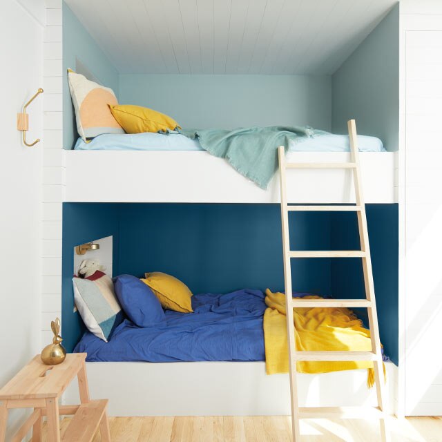 A bunk bed alcove with two-tone blue walls