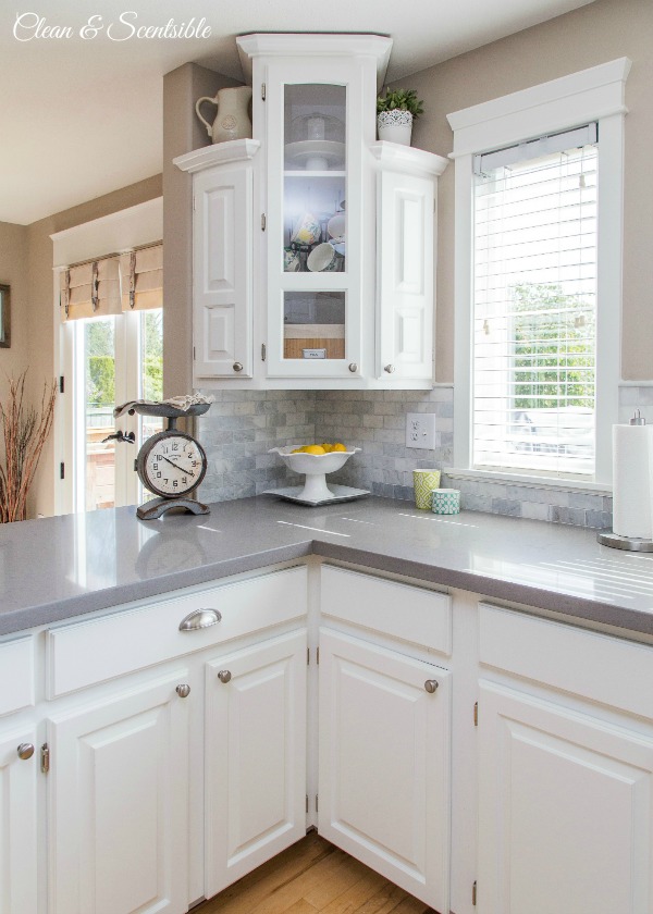 Beautiful white kitchen with grey quartz countertops.