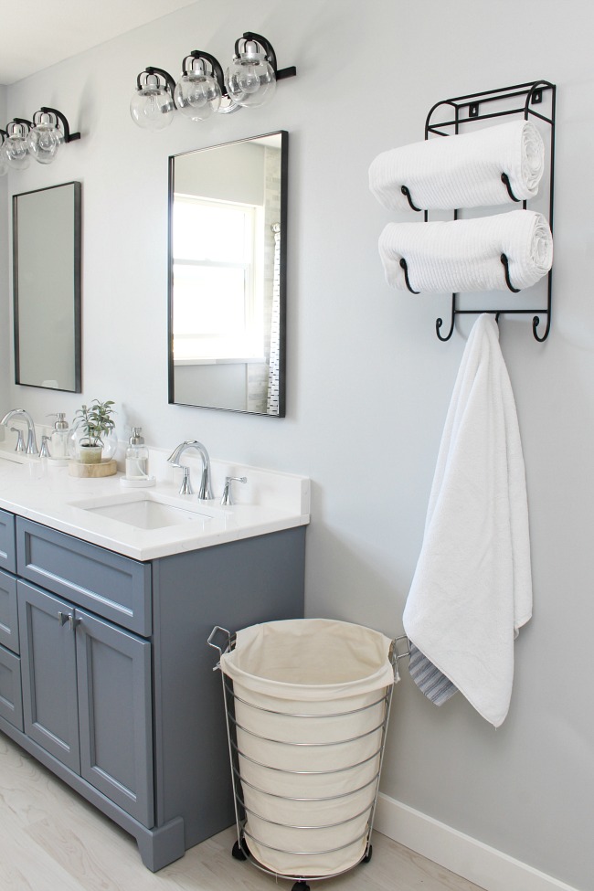 Coastal style bathroom with soft greys and black and chrome accents.