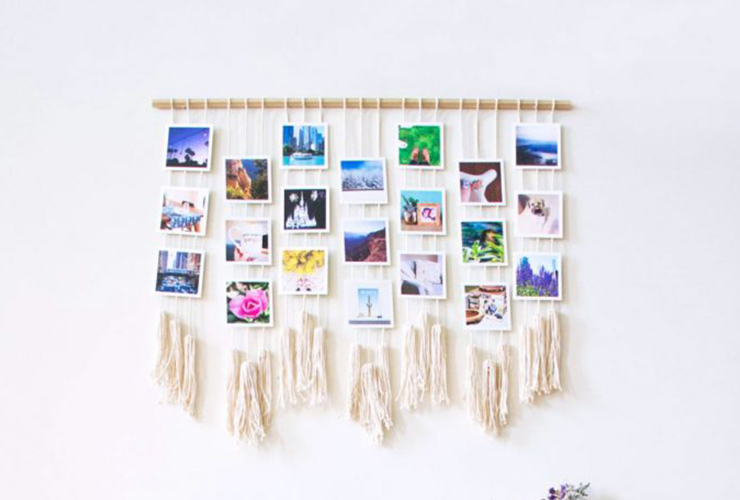 Photos hang on a macrame display 